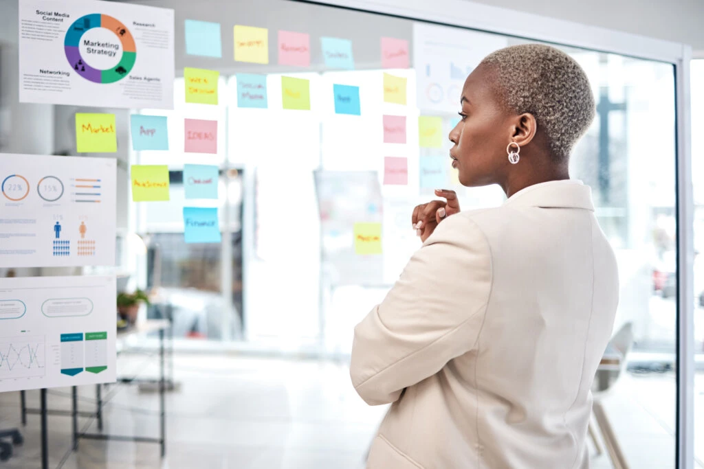 African American woman looking at marketing metrics reporting