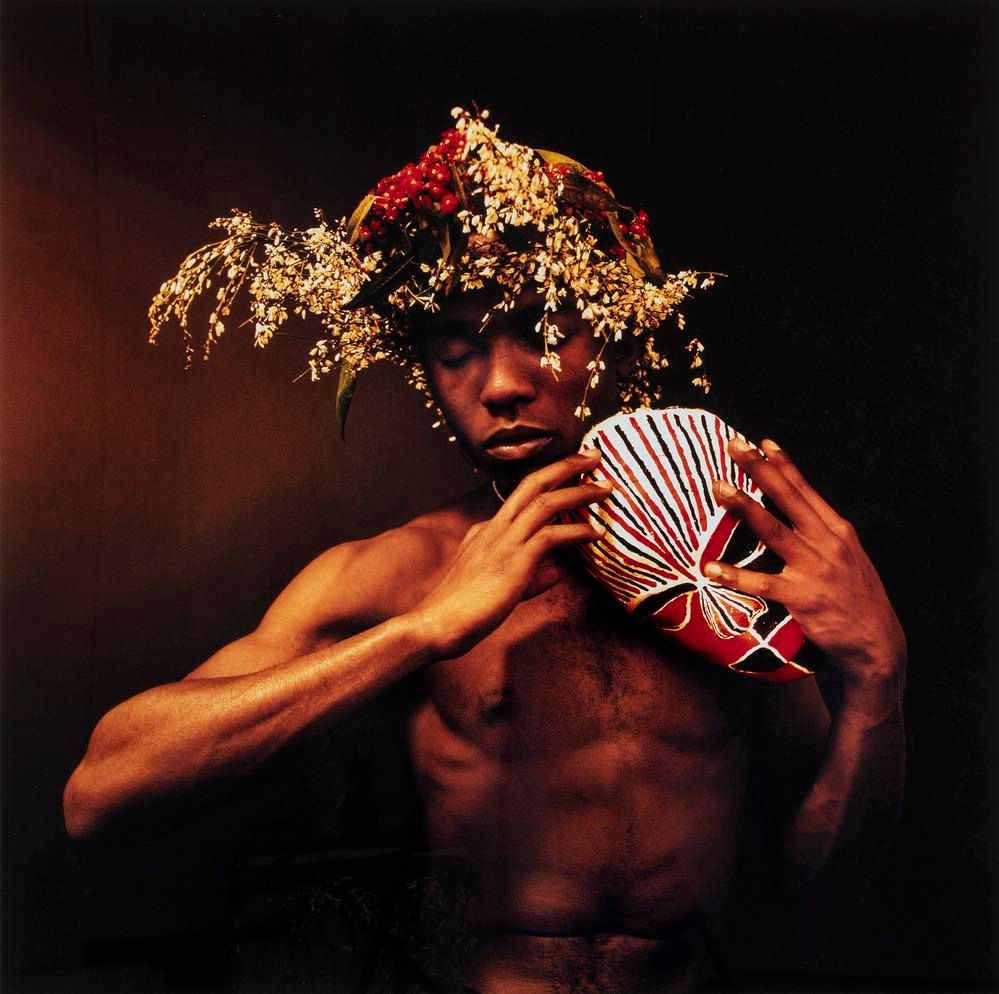 photo of a man holding a mask