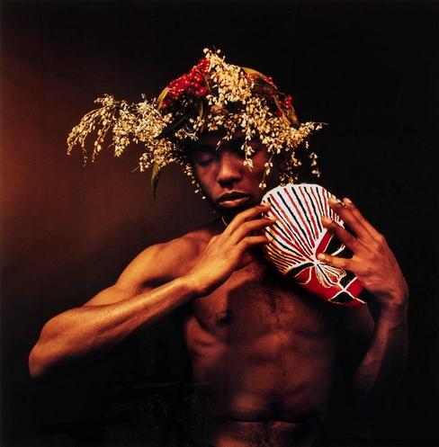 photo of a man holding a mask