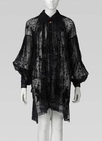 Sheer black blouse dress by fashion designer Vivienne Westwood, featuring a delicate embroidered pattern, collar and voluminous sleeves, displayed on a mannequin.