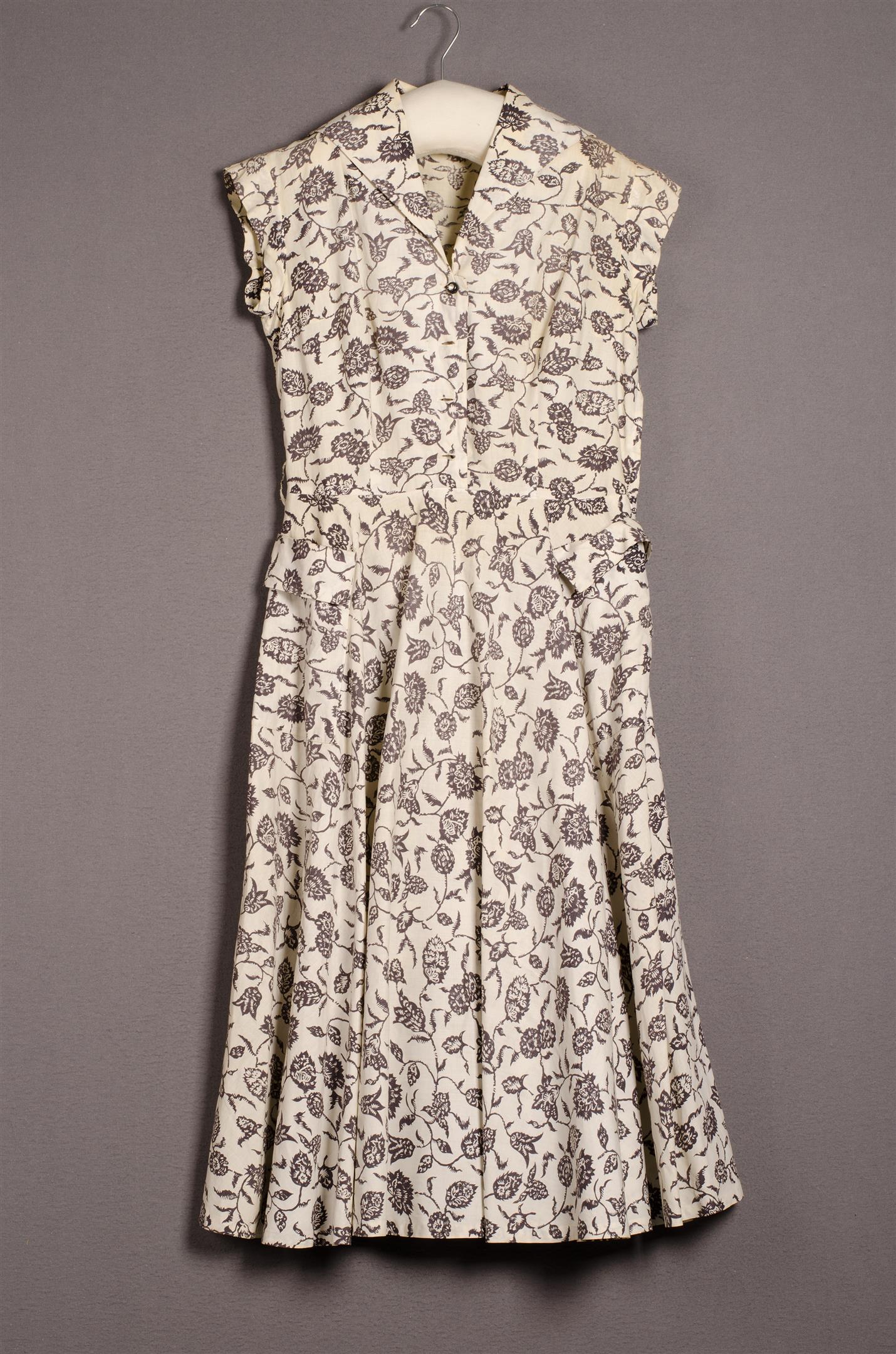 Women's two-piece ensemble consisting of a jacket and skirt with a red and pink pattern.