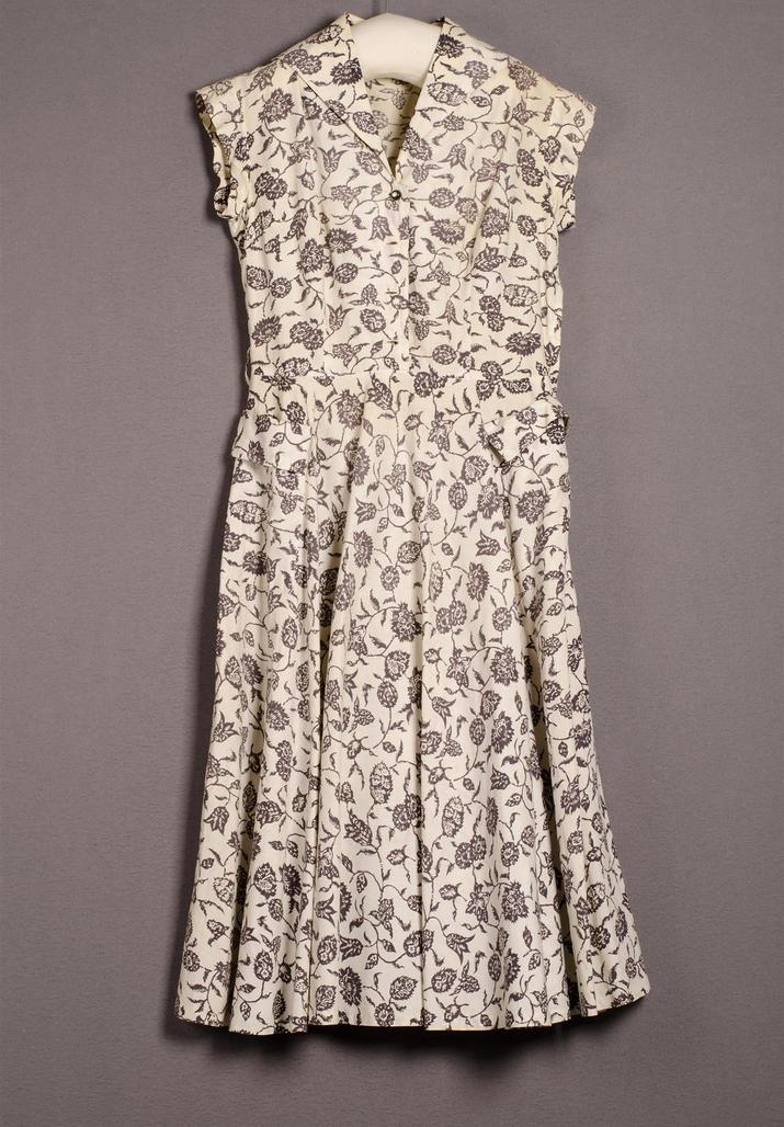 Women's two-piece ensemble consisting of a jacket and skirt with a red and pink pattern.