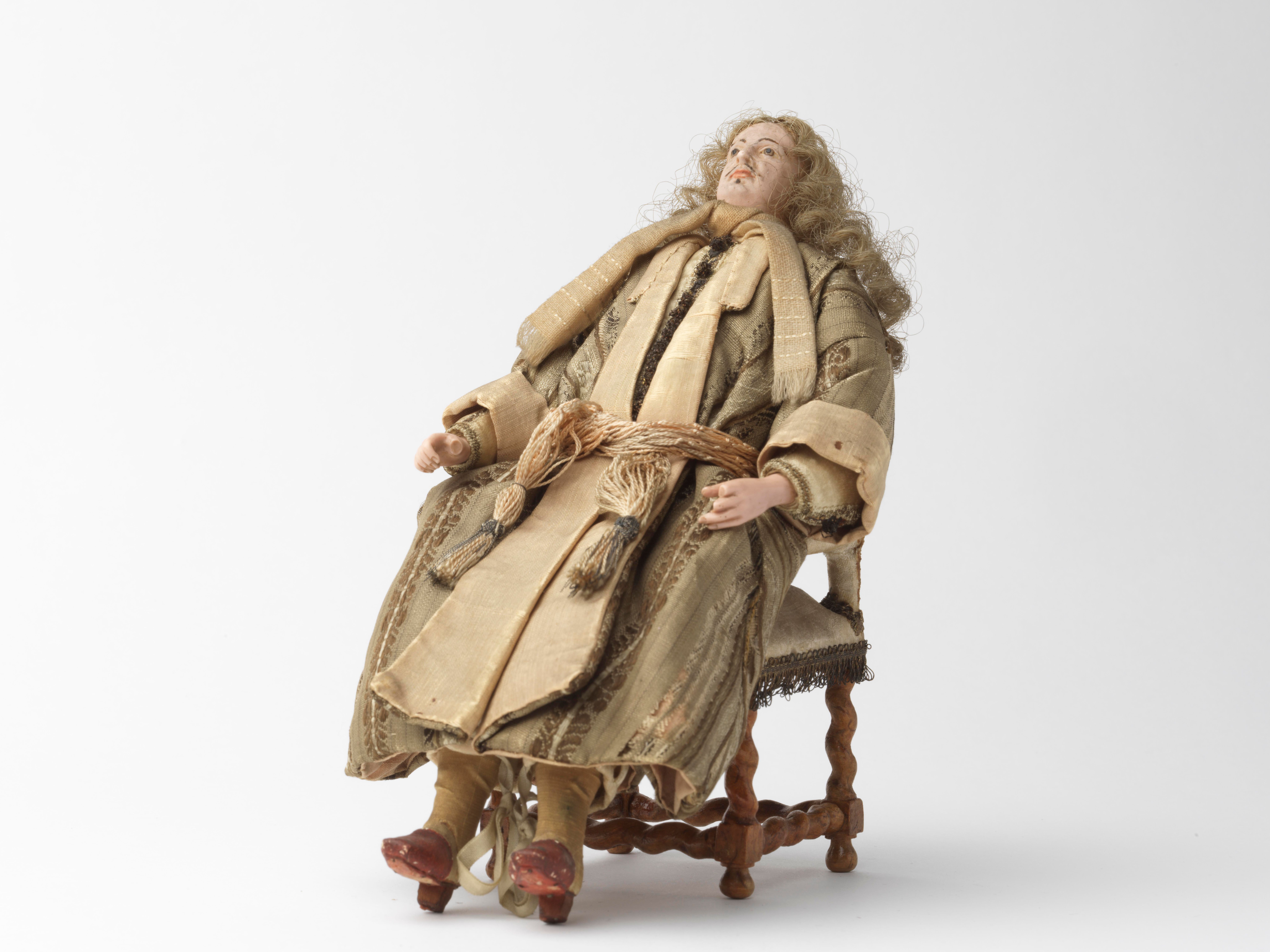dollhouse doll wearing a silk dressing gown