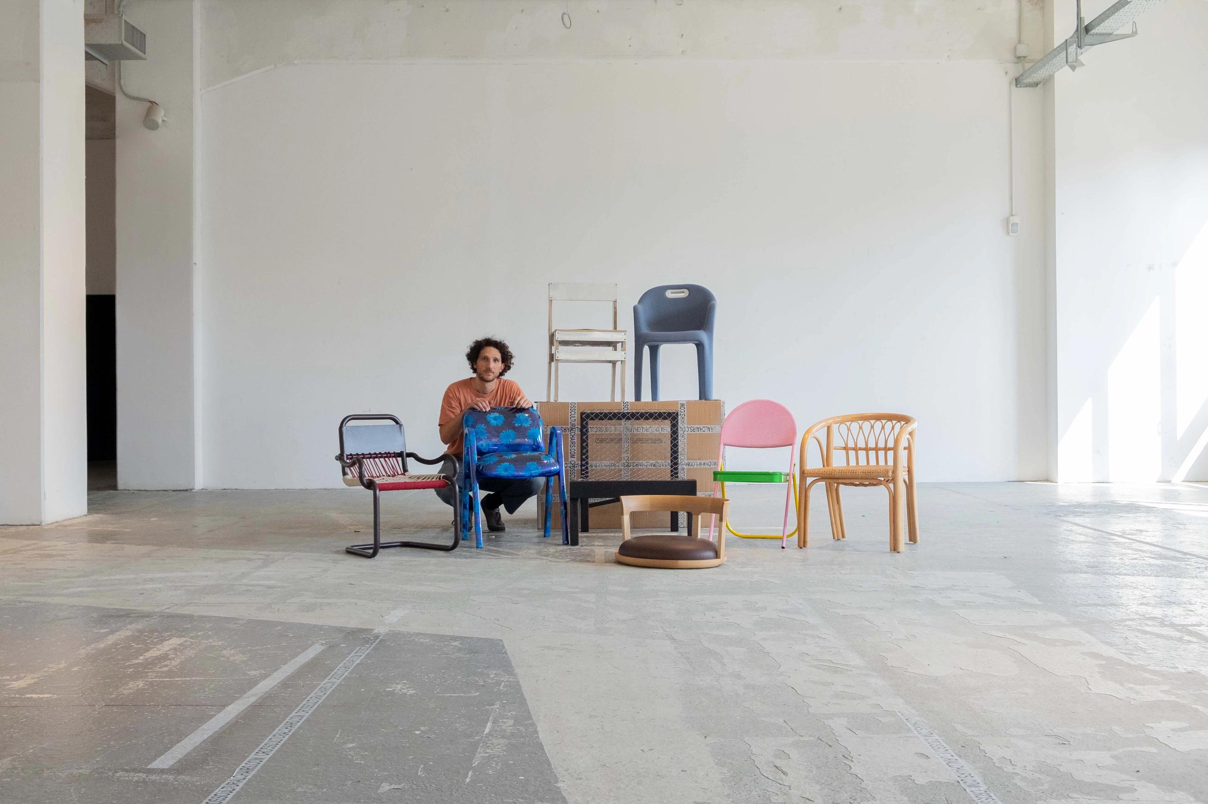 Designer Matteo Guarnaccia with all his chairs