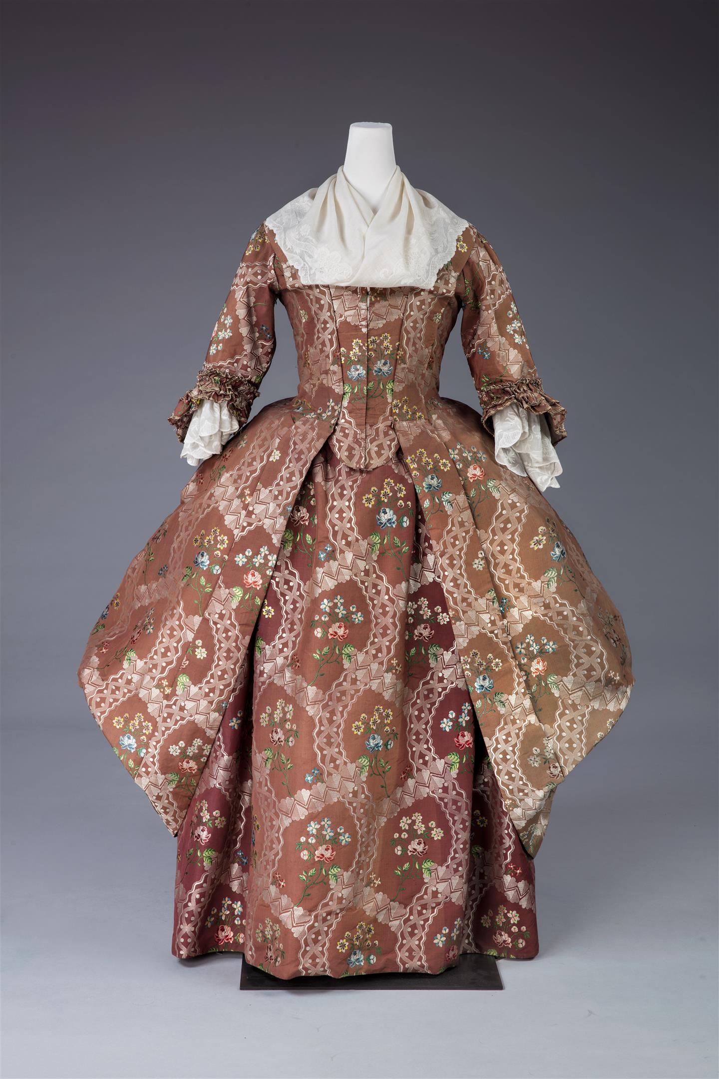 The cinched waist of a brown floral dress for women. 