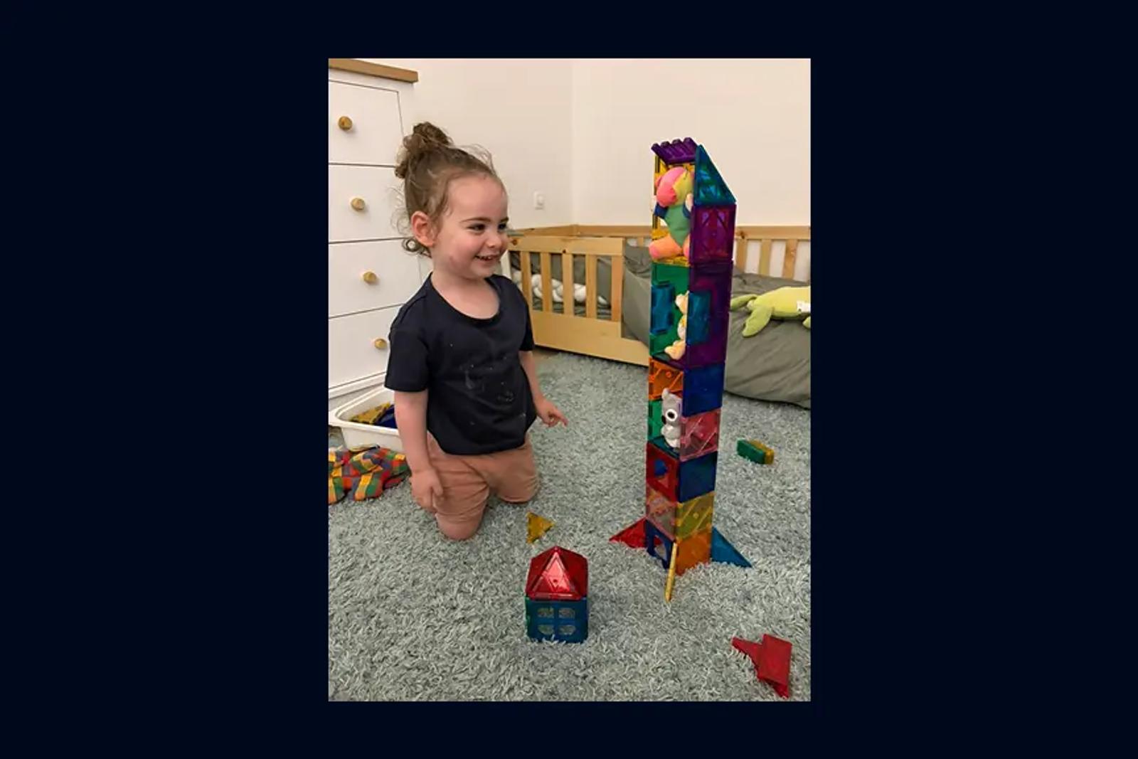 My son building a tall tower