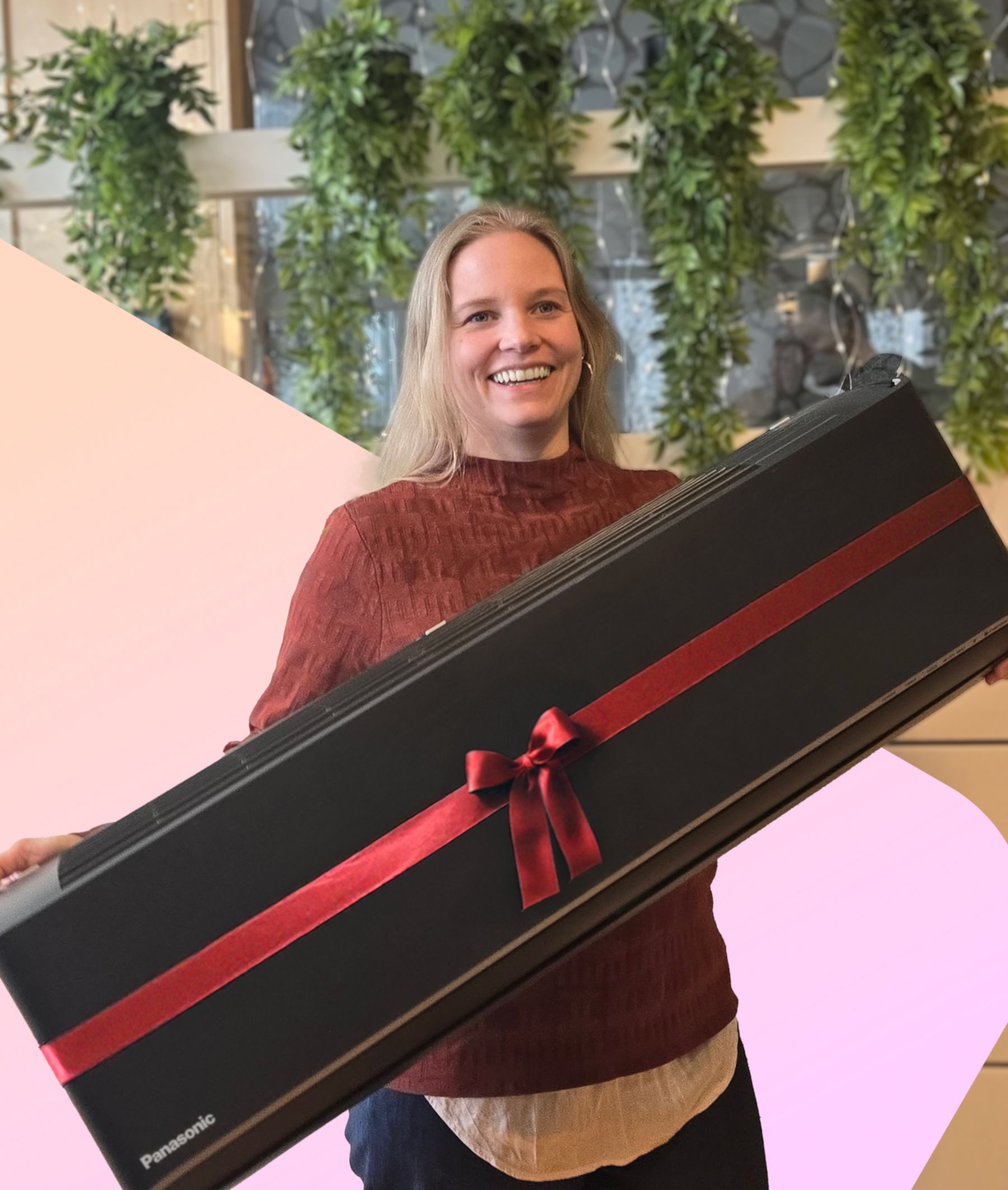 Ansatt i Ishavskraft poserer med Panasonic-varmepumpe