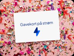 Gavekort på strøm som ligger oppå en rosa bakgrunn med konfetti i mange farger.