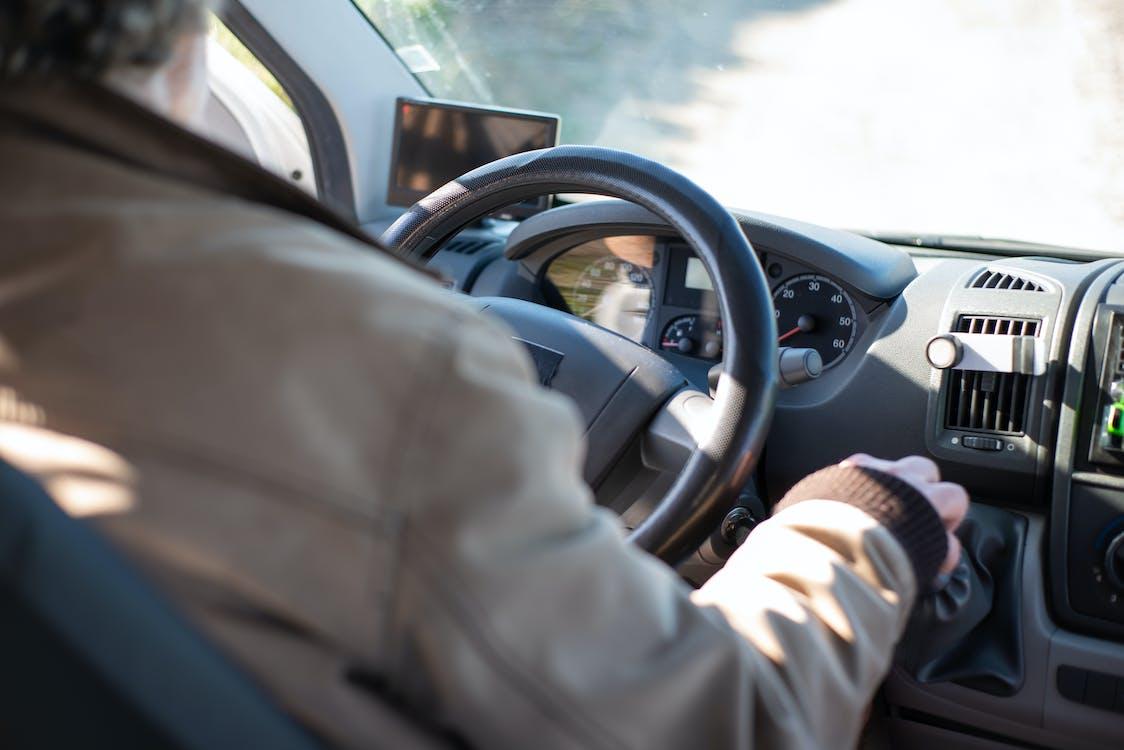 Free Person in White Long Sleeve Shirt Driving Car Stock Photo