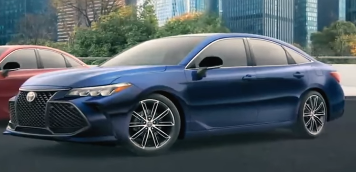 A blue car parked on the side of the road Description automatically generated with low confidence