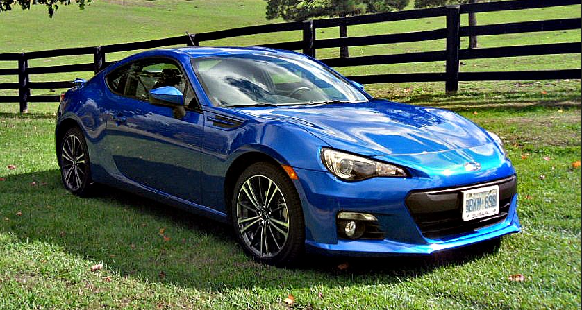 A blue car parked on grass Description automatically generated with medium confidence