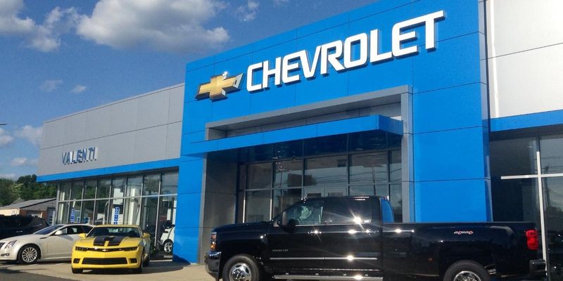A black truck in front of a store Description automatically generated with low confidence