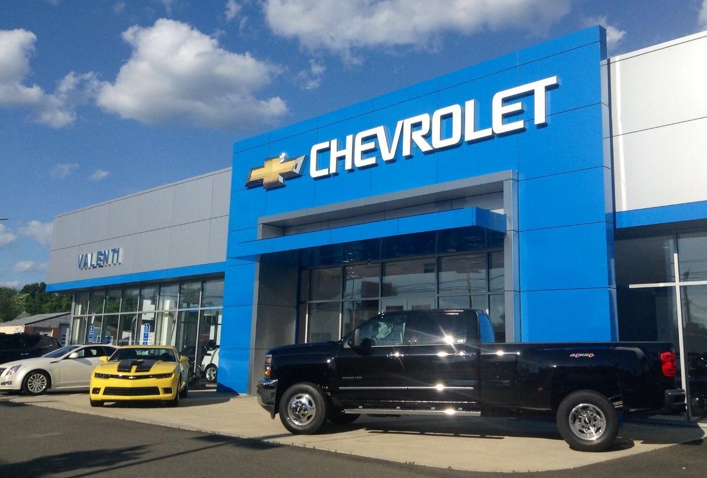 A black truck in front of a store Description automatically generated with low confidence