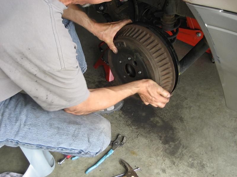 A person working on a tire Description automatically generated with low confidence