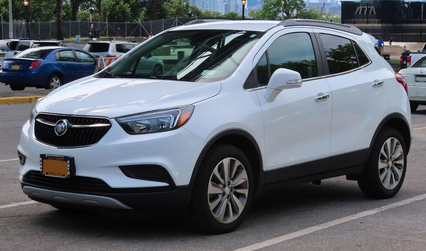 A white car parked in a parking lot Description automatically generated with medium confidence