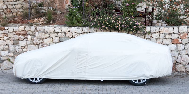 passenger-car-covered-white-sheet-on