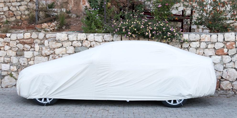 passenger-car-covered-white-sheet-on