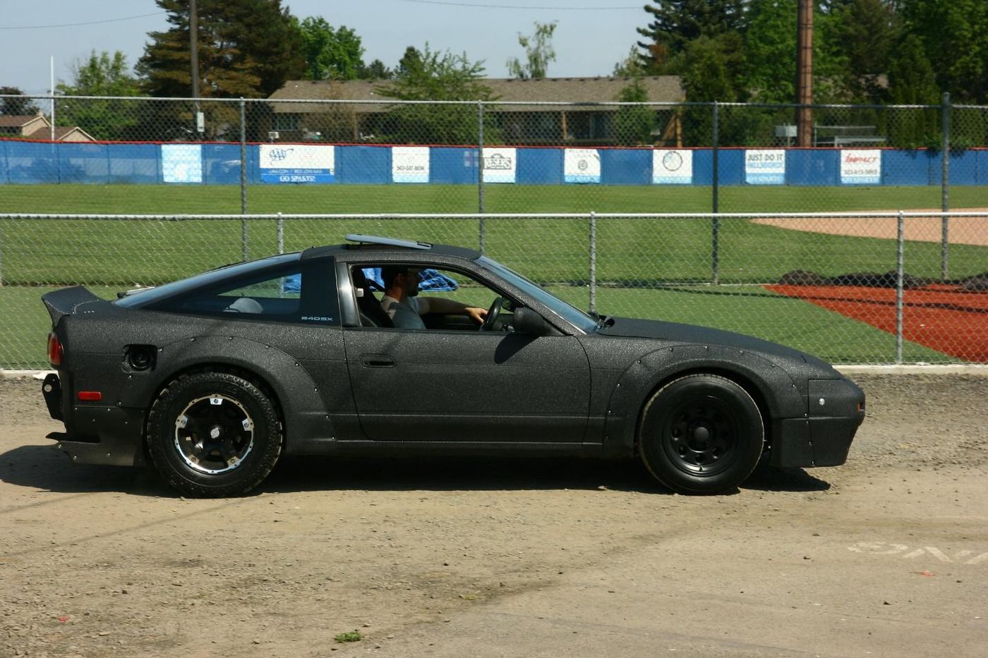 A black car on a track Description automatically generated with medium confidence