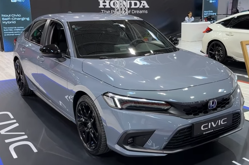 A picture containing text, car, road, parked Description automatically generated