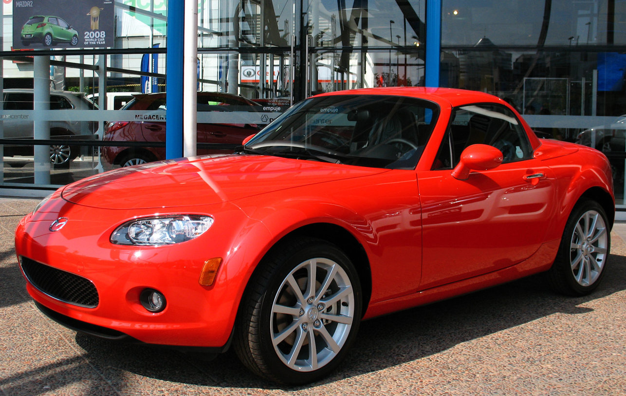 A red car parked in a building Description automatically generated with low confidence
