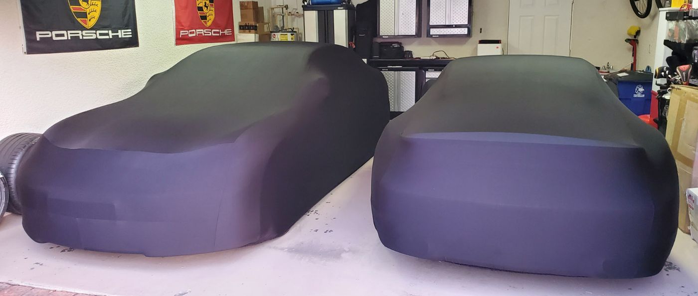 2 cars covered with indoor black satin shield car covers