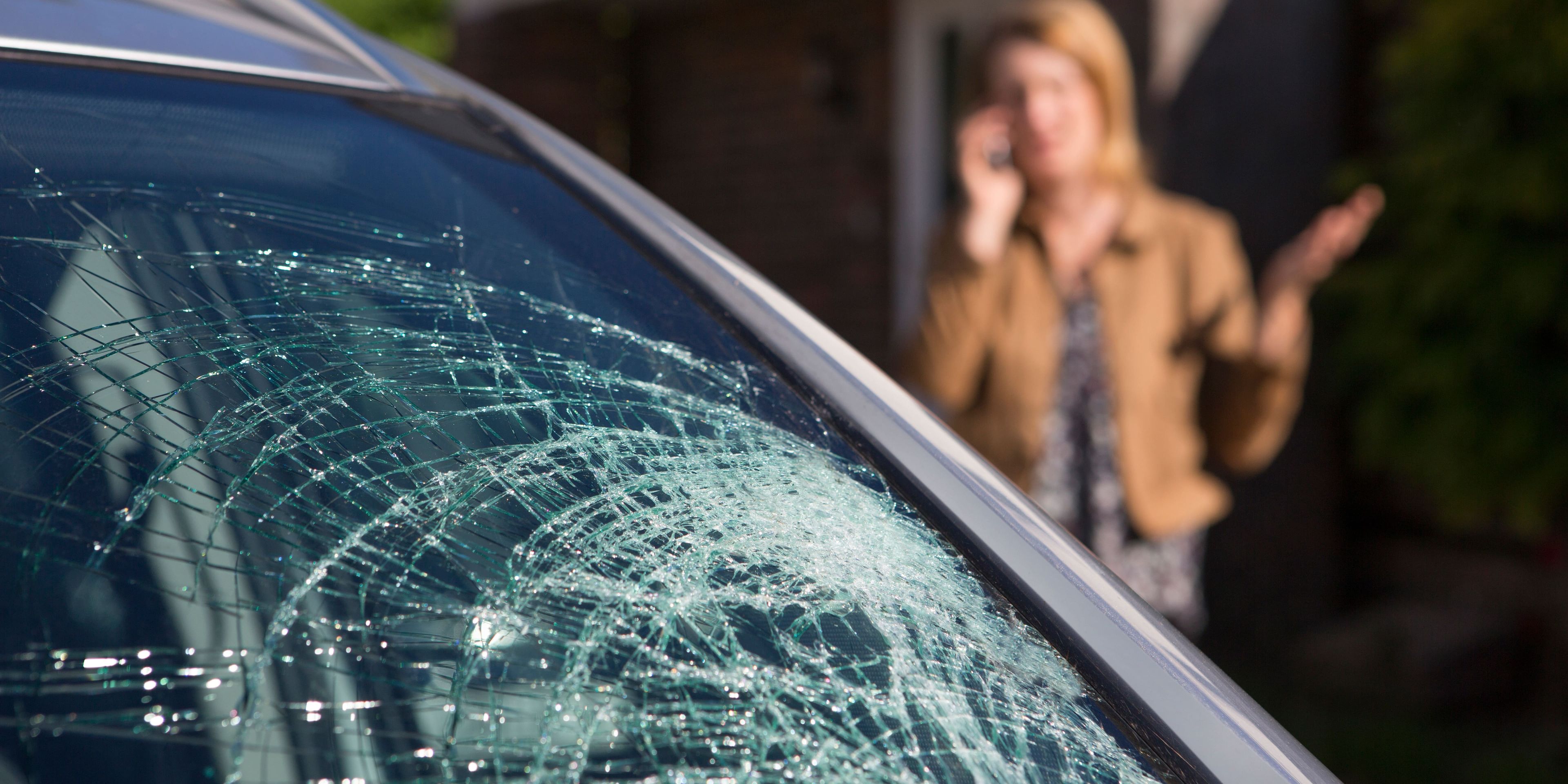 woman-phoning-help-after-car-windshield