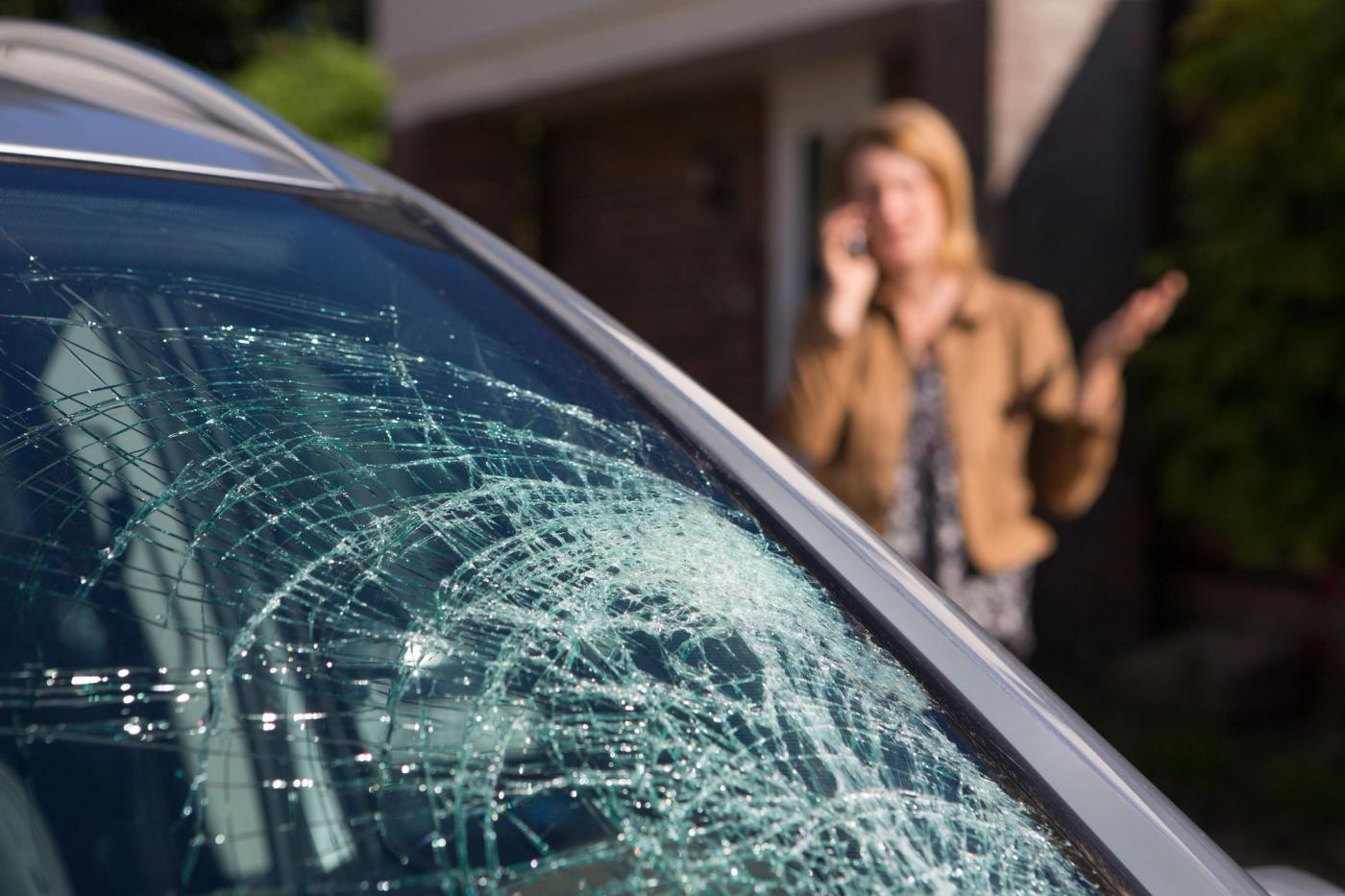 woman-phoning-help-after-car-windshield