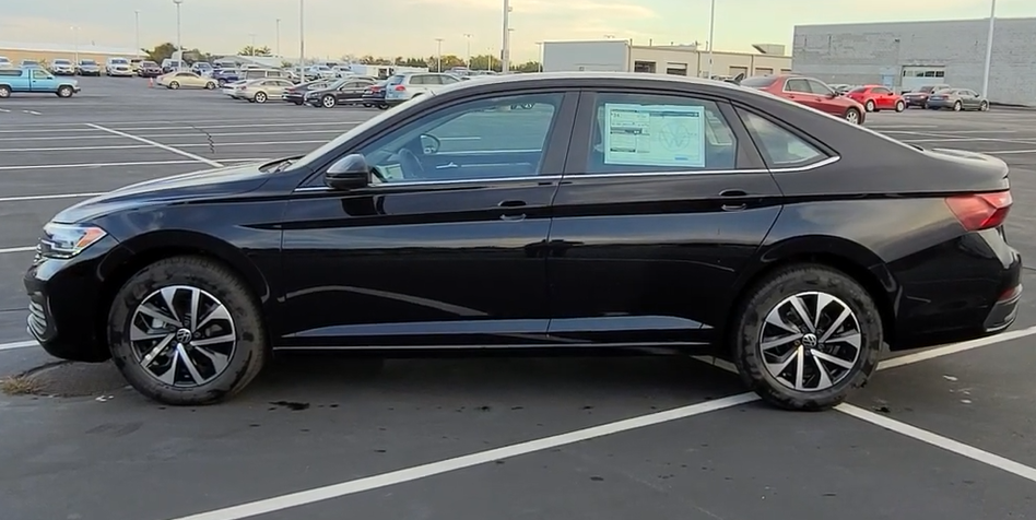 A black car parked in a parking lot Description automatically generated
