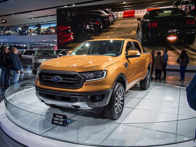 golden yellow pickup truck on display