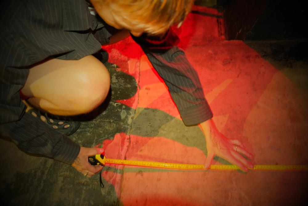 Image of a person with a measuring tape completing the access audit.