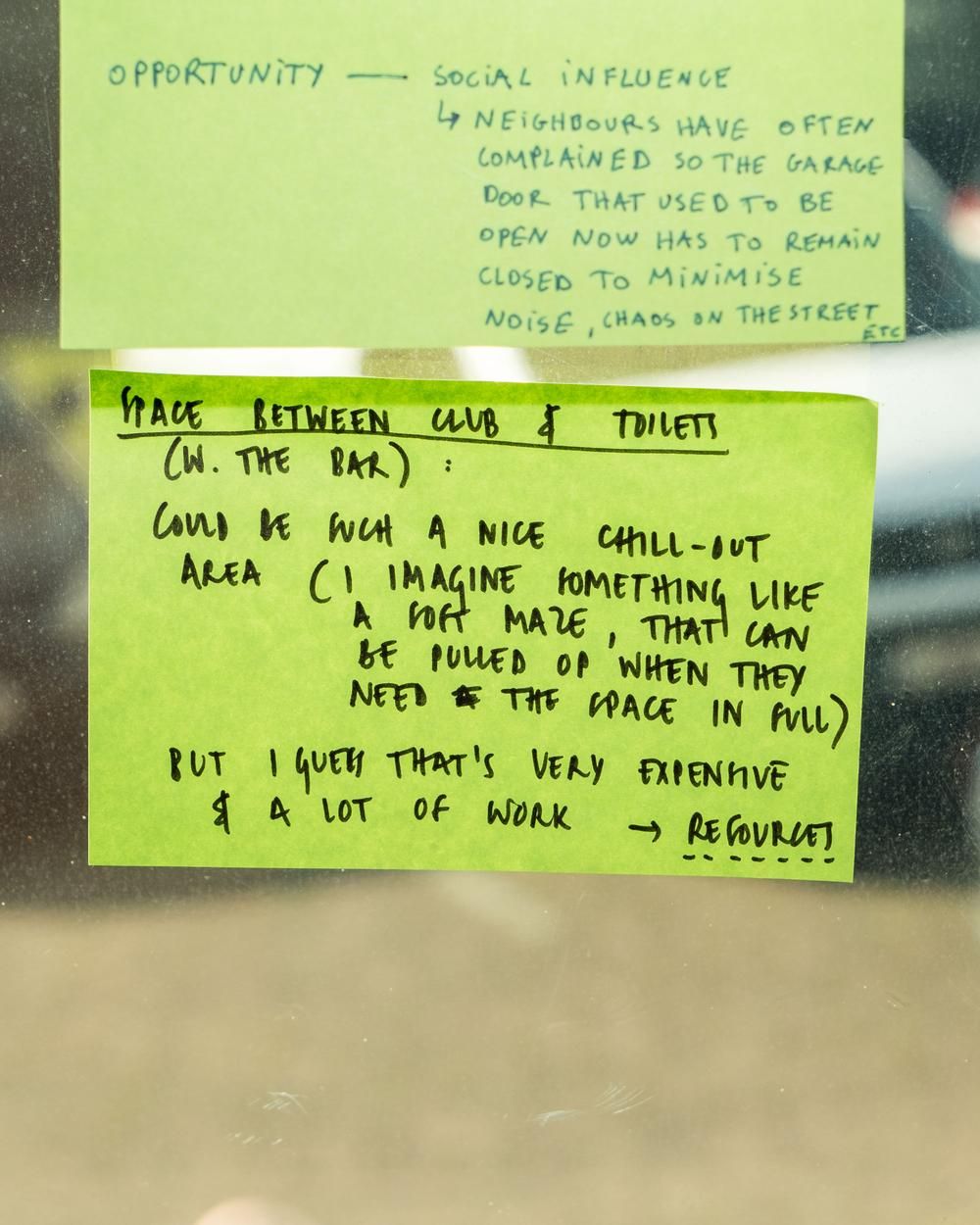 A window with post-its and text written on them.