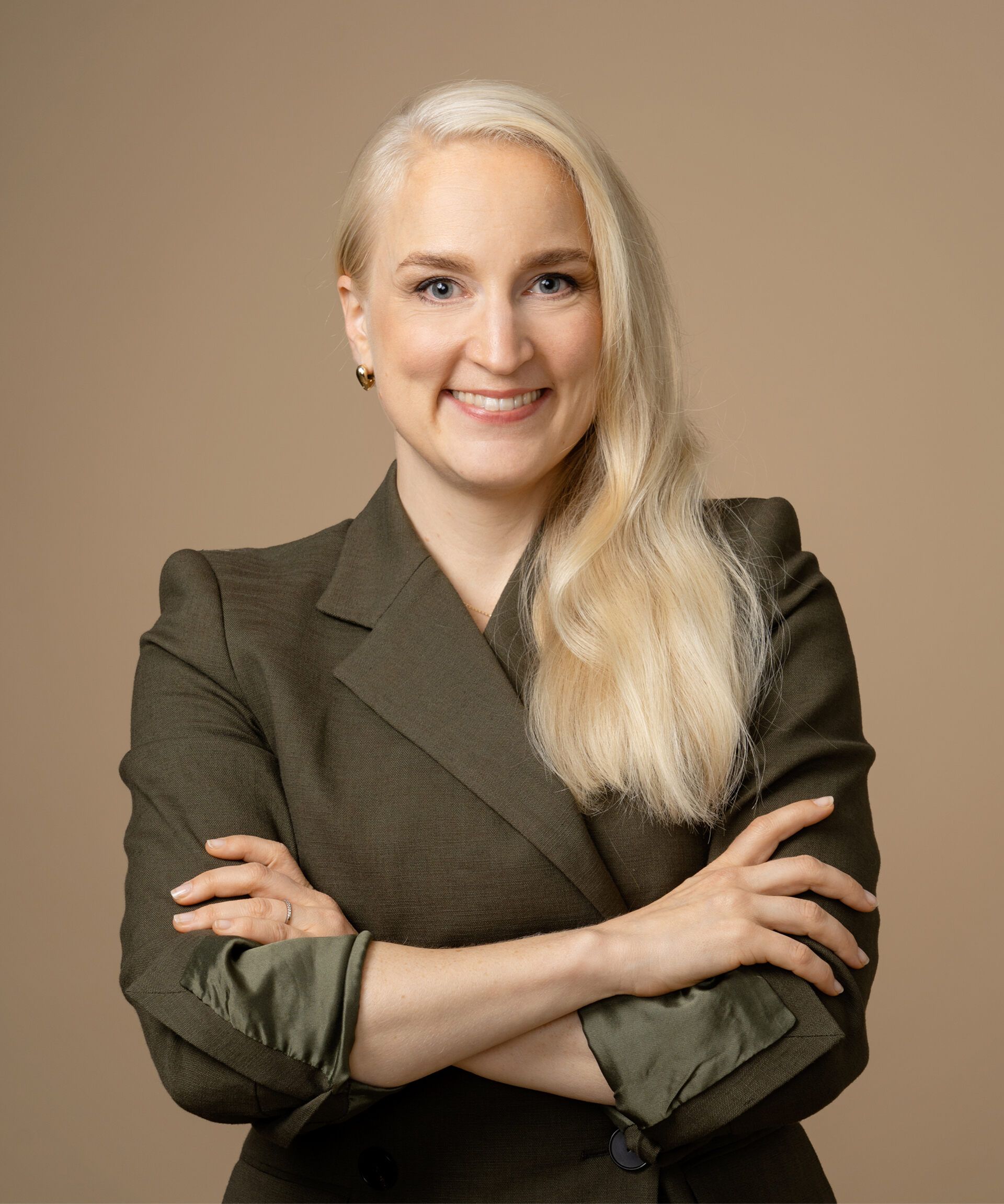 A blonde woman with straight hair in a black polo