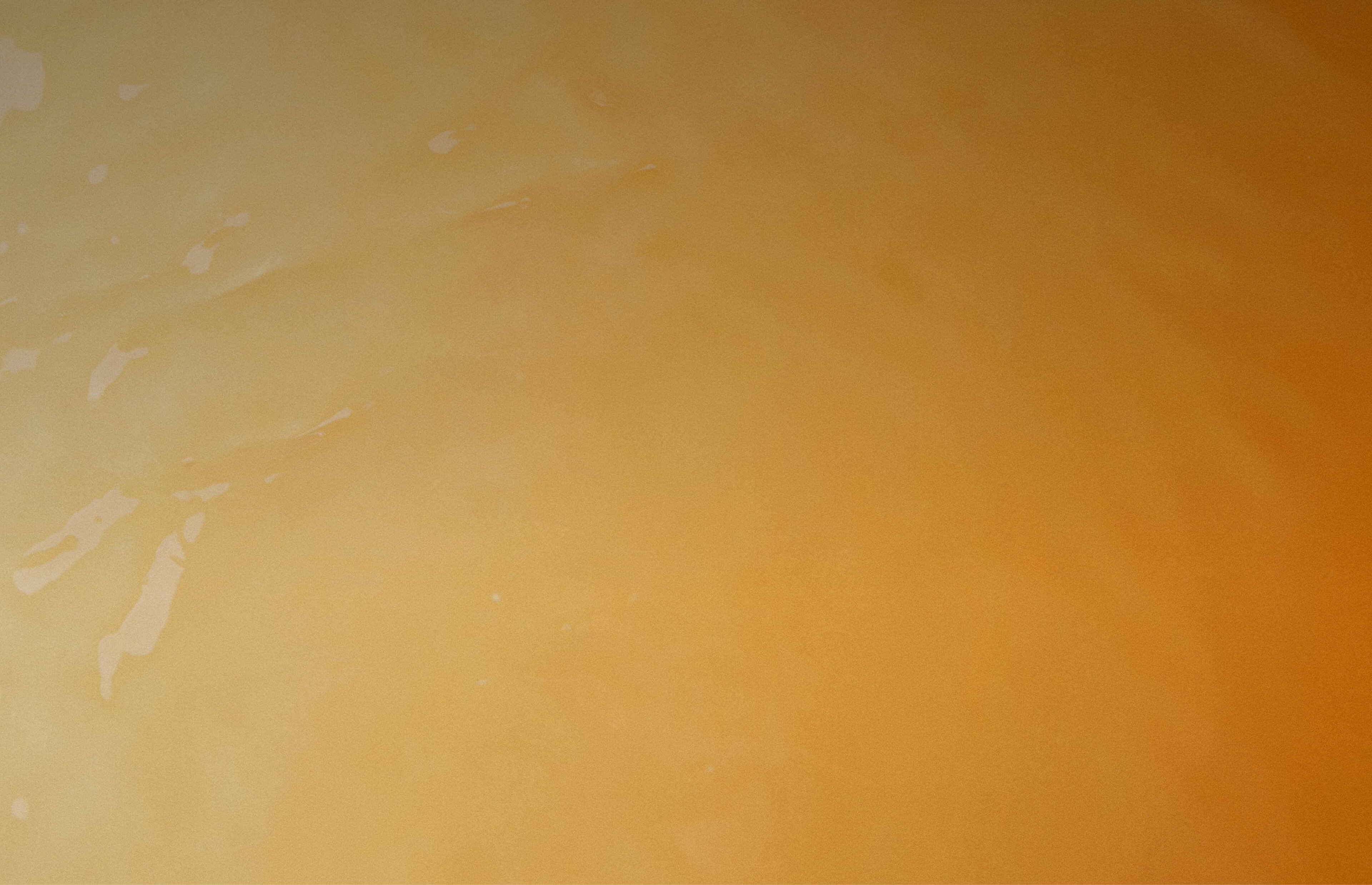 An orange liquid calmly rippling into the distance.