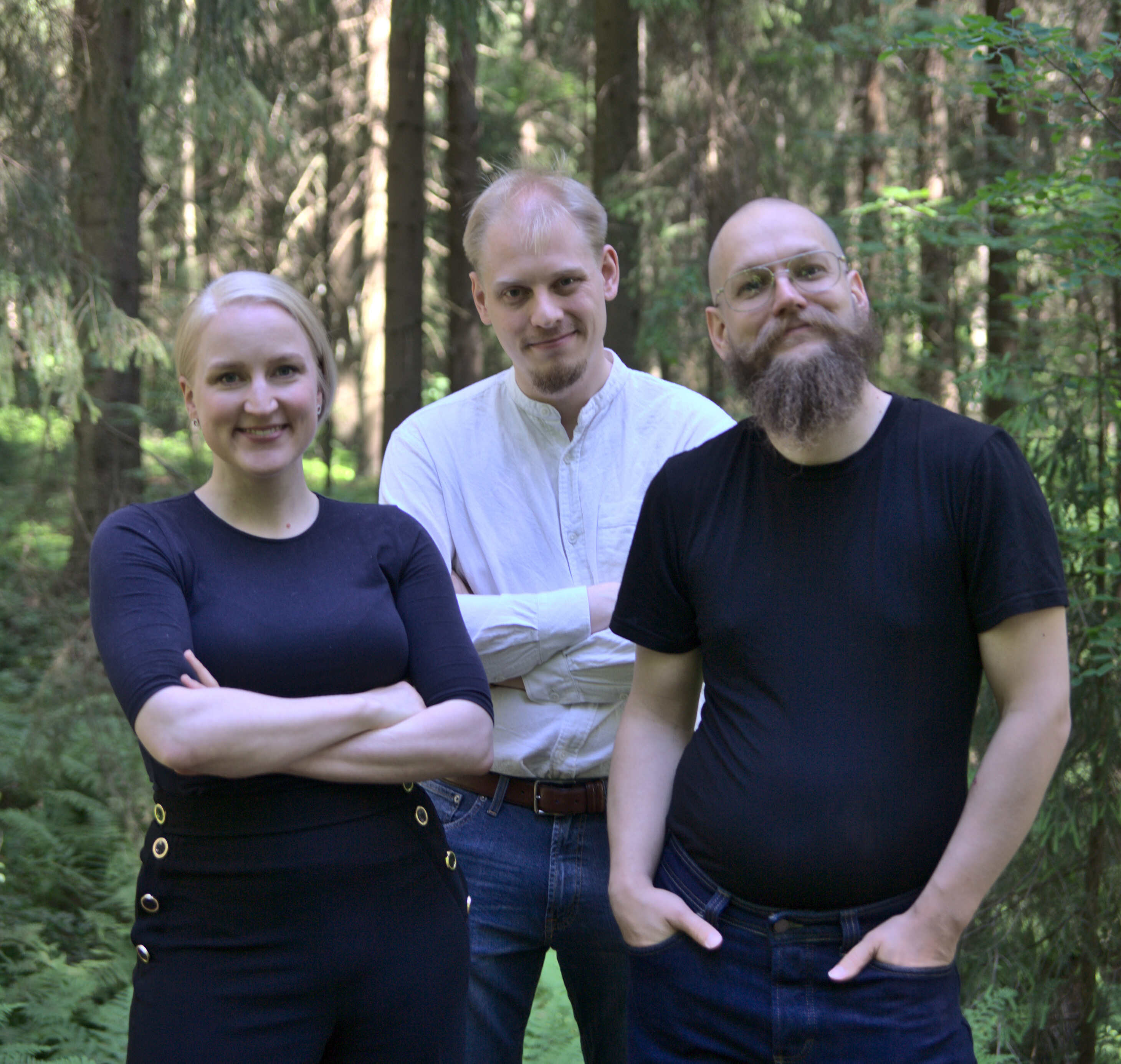 A smiling Volare team in a forest