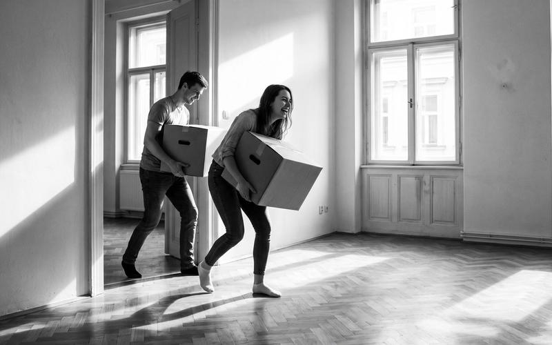 Students unpacking boxes in a shared flat in Prague
