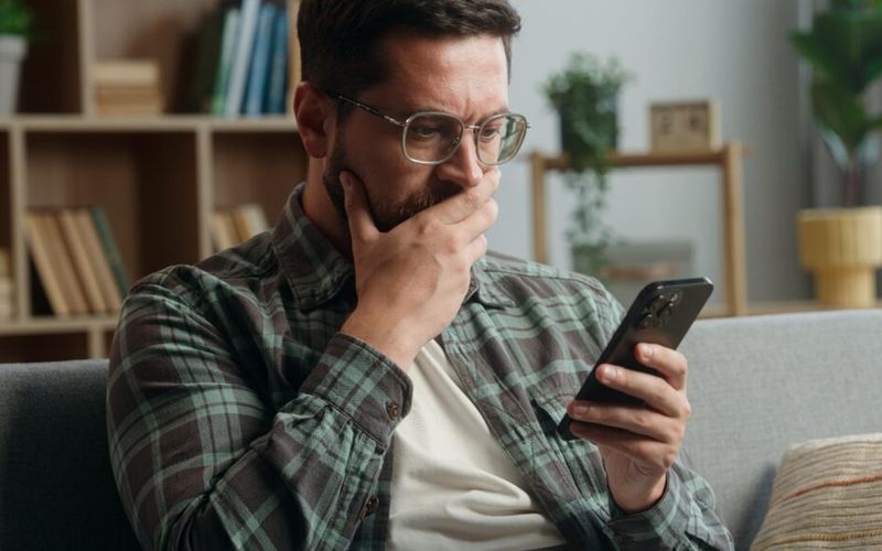 A person scrolling through rental listings on a phone