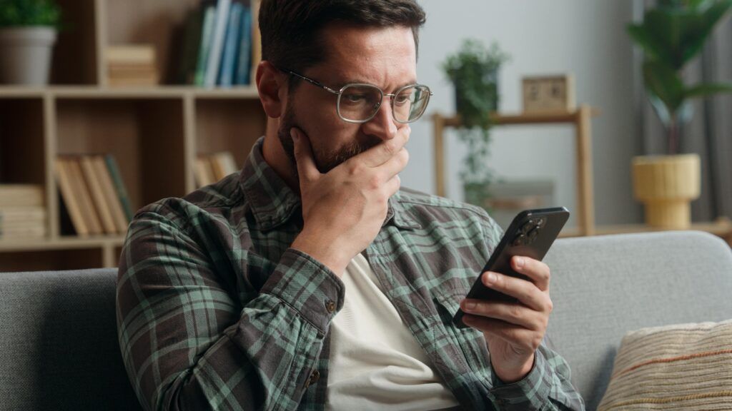 A person scrolling through rental listings on a phone