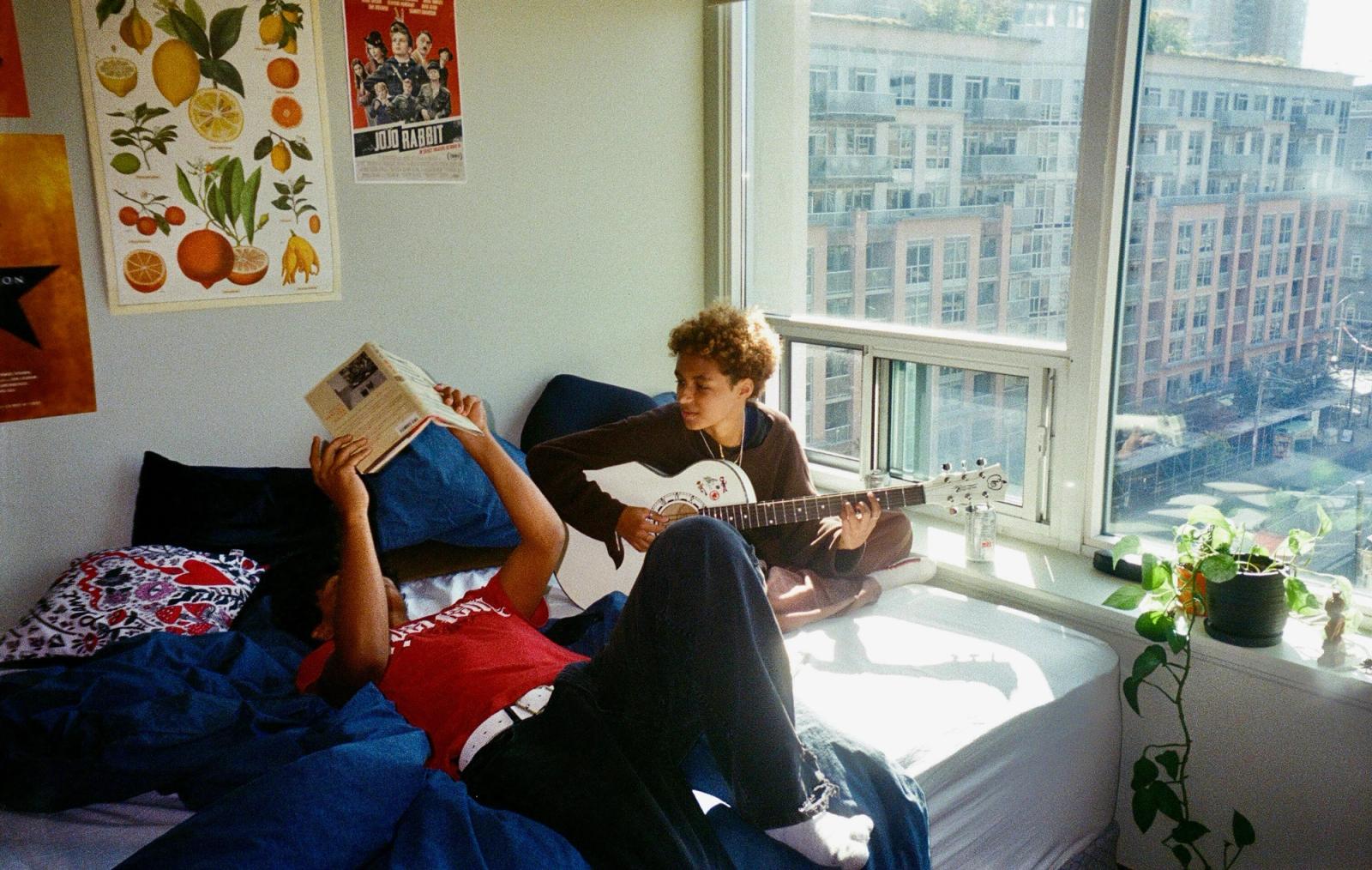 Two roommates relaxing together in a sunlit Prague apartment