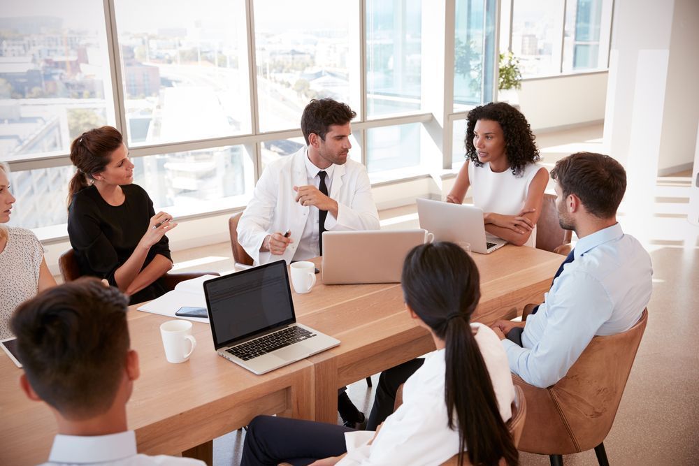 Healthcare professionals having a discussion during a meeting in a modern office