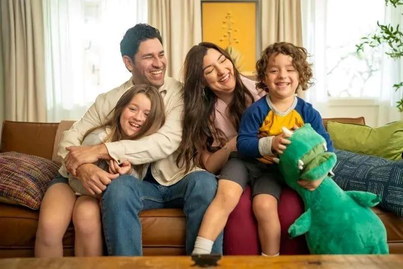 The Best Whole House HVAC Air Freshener System for Home - image of aThe Best Whole House HVAC Air Freshener System for Home - image of a happy family sitting on a couch, smiling and laughing together. happy family sitting on a couch, smiling and laughing together.