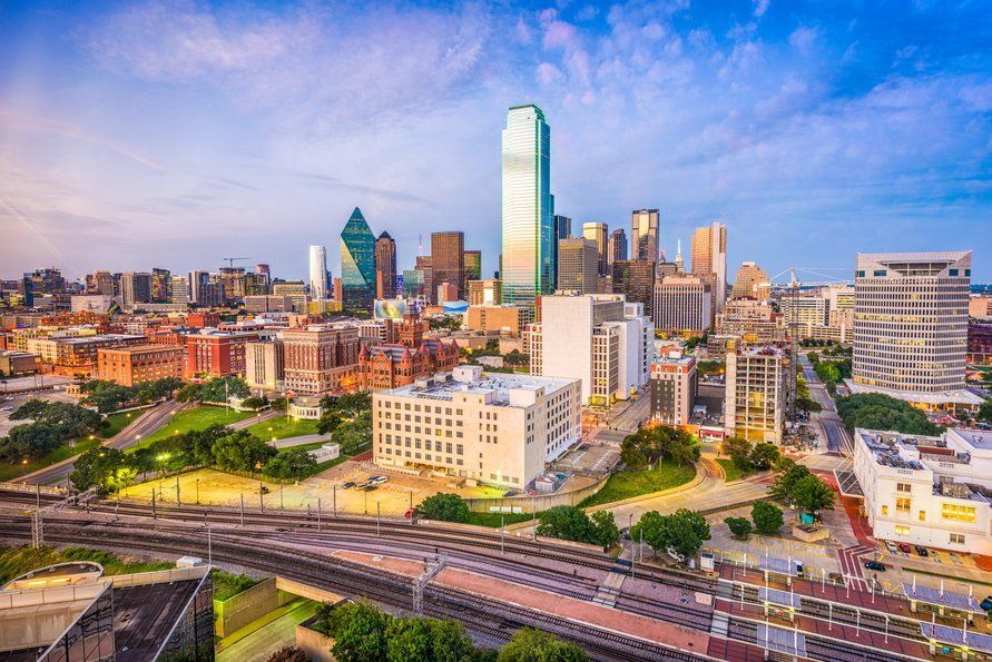 Bright urban skyline with rail tracks in the foreground during golden hour