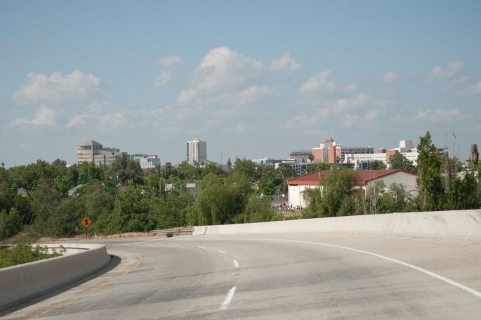 U.S. Cities with Worst and Best Air Quality - Infographics of Fresno's downtown area bathed in warm golden hour light, a city where agriculture and industrial activities can sometimes influence air quality