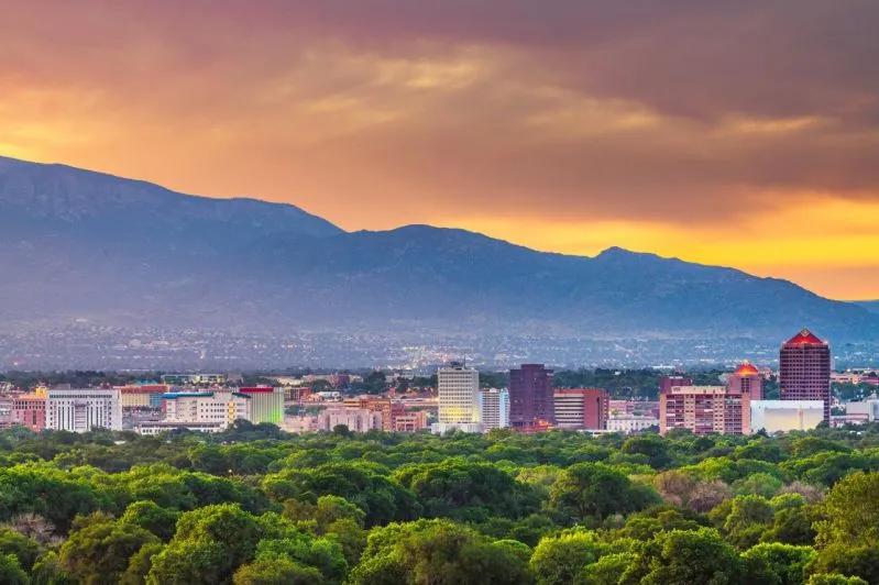 View of Albuquerque skyline at sunset illustrating New Mexico’s rising eviction and foreclosure risks.