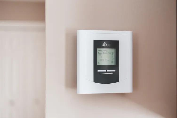 Smart thermostat display showing energy-efficient settings for optimal HVAC operation.