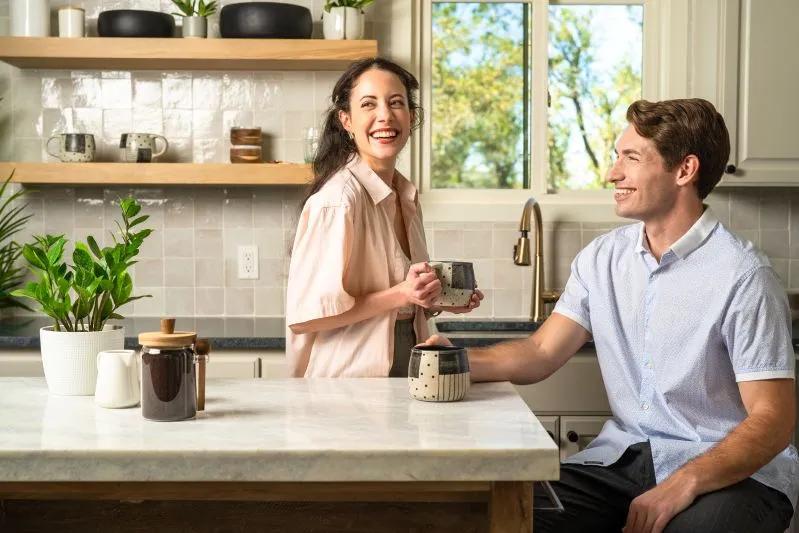Discover the Benefits of the Best Aromatherapy Essential Oil Diffuser - image of a smiling couple enjoying coffee in a bright kitchen.