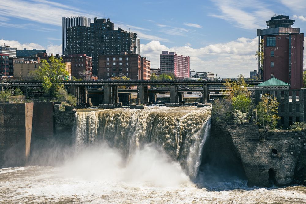 High Falls waterfall in Rochester, New York with urban buildings in the background