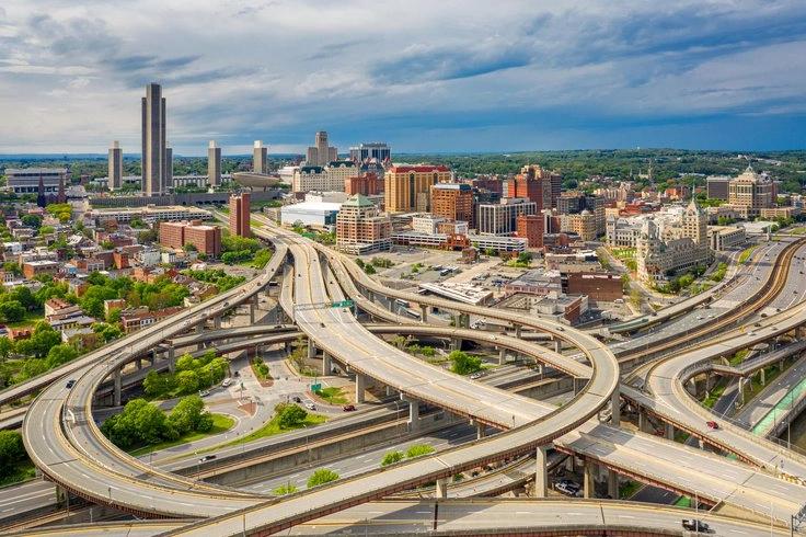 States and Counties With the Highest Rates of Lung Cancer - Infographics of a modern urban skyline at sunset, showcasing states with energy-efficient buildings and lower emissions per capita.