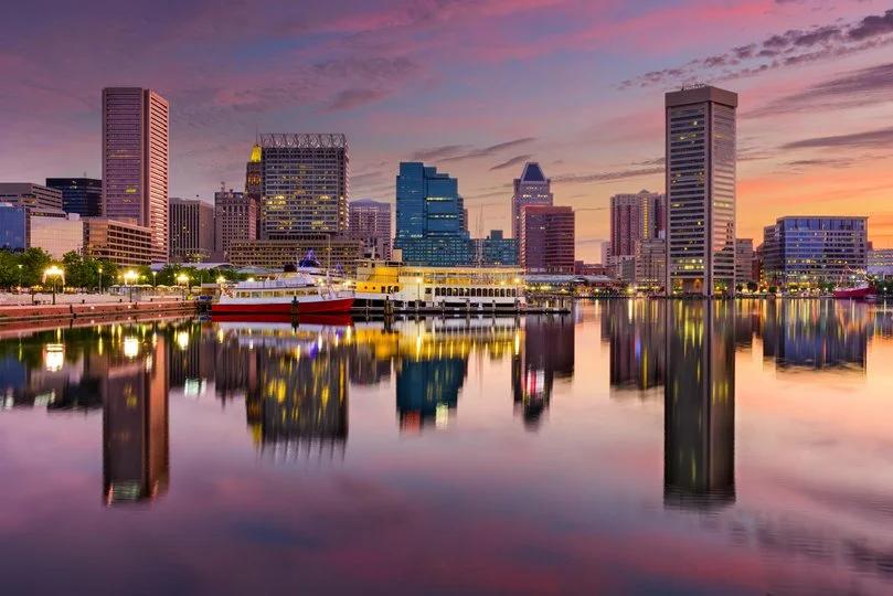Image of Baltimore, Maryland skyscrapers in downtown with its ferries mooored on its calm sea.