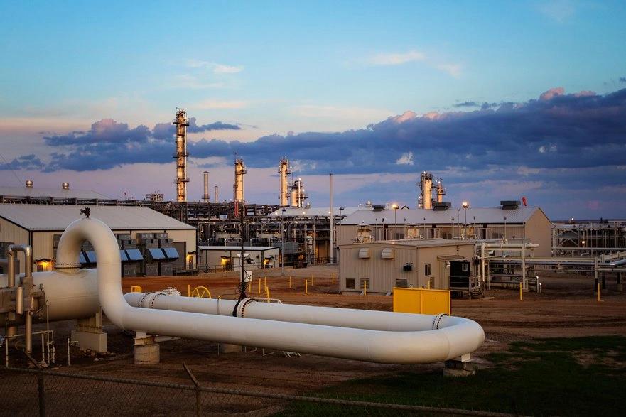 States and Counties With the Highest Rates of Lung Cancer - Infographics of a natural gas processing facility under a colorful sky, representing states shifting from coal to gas to reduce emissions.