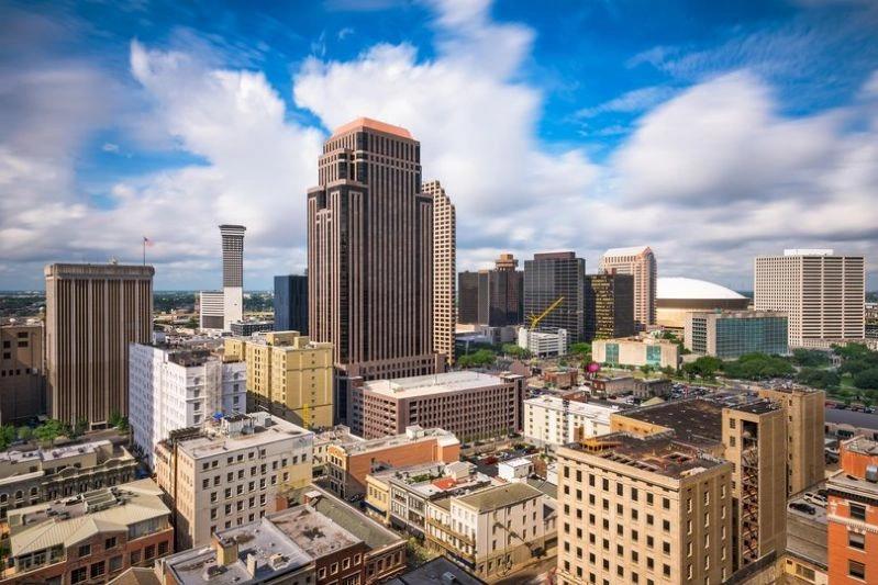 Cities with the Biggest Declines in Air Pollution - Image of a daytime view of the New Orleans skyline, featuring tall buildings and the Superdome in the distance.